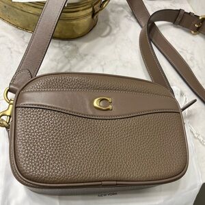 Coach crossbody. Gold emblem and embellishments. New. Includes the storage bag.